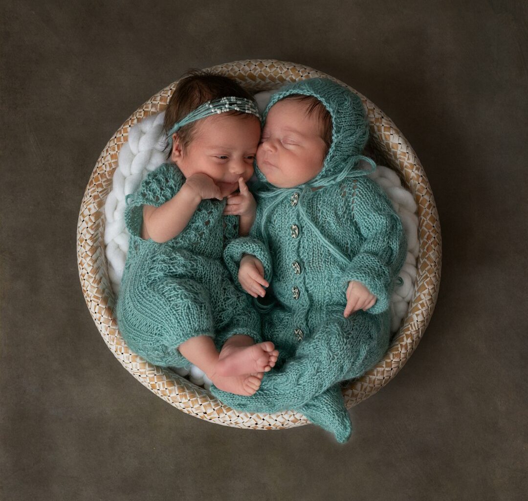 a couple of babies laying next to each other