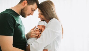 a man and woman holding a baby in their arms