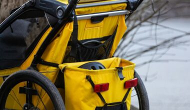 A yellow stroller parked next to a tree